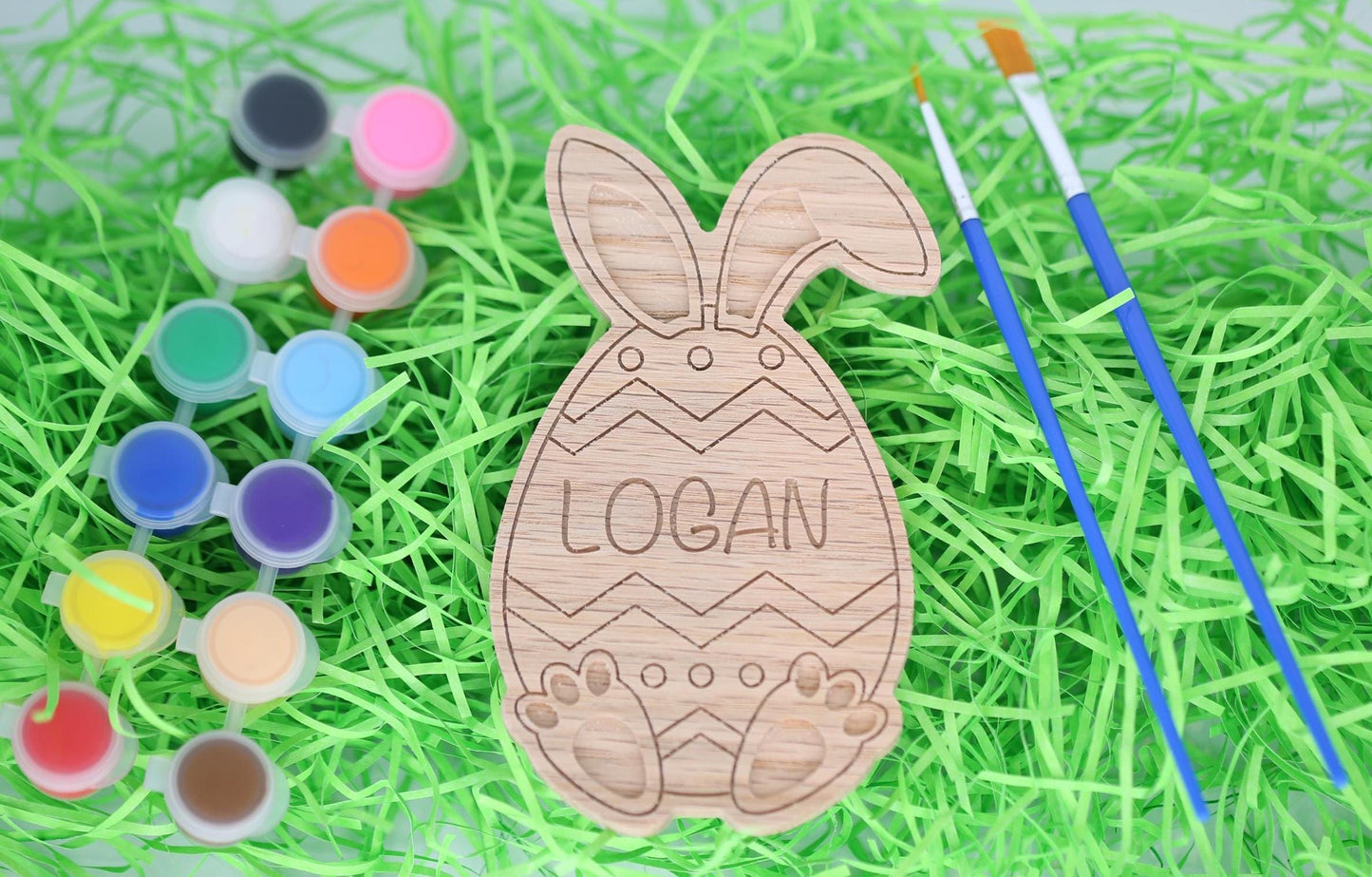 Easter egg paint craft kit with paint pots, paintbrushes and personalized Easter egg with bunny ears and bunny feet.