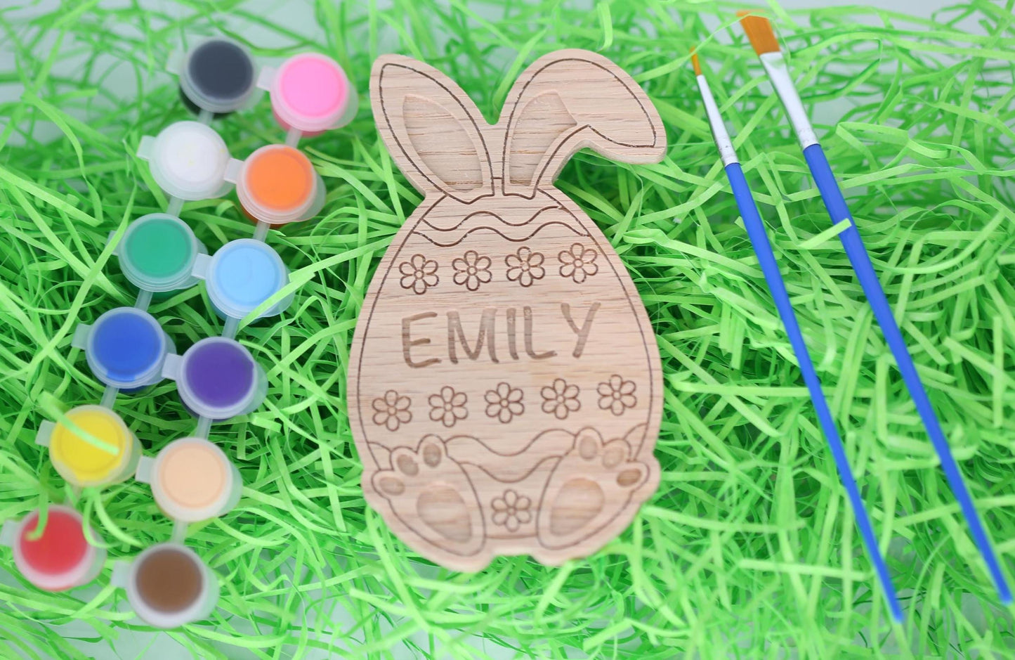 Easter egg paint craft kit with paint pots, paintbrushes and personalized Easter egg with bunny ears and bunny feet.