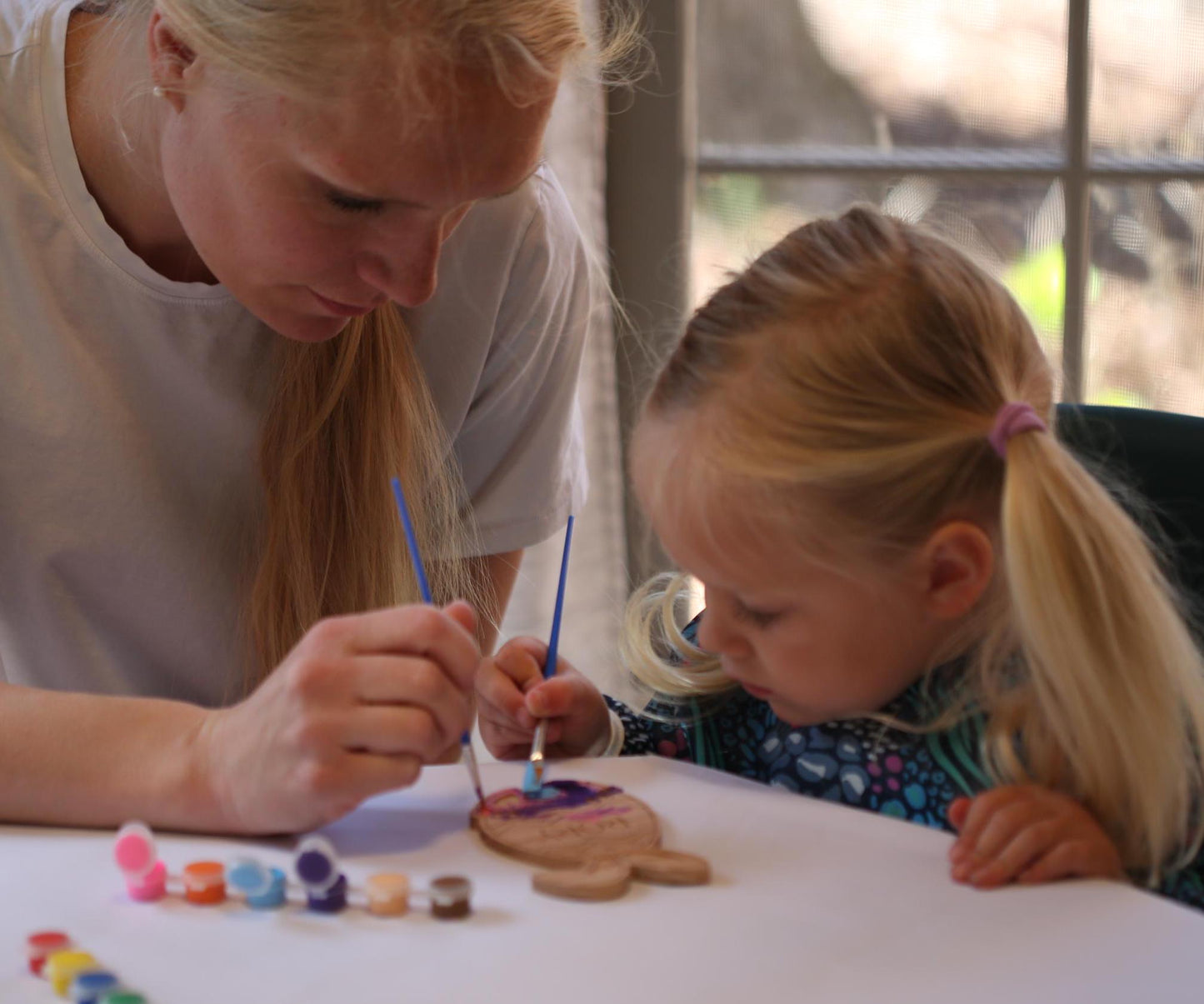 Mother and child painting using the Easter Egg Paint kit.