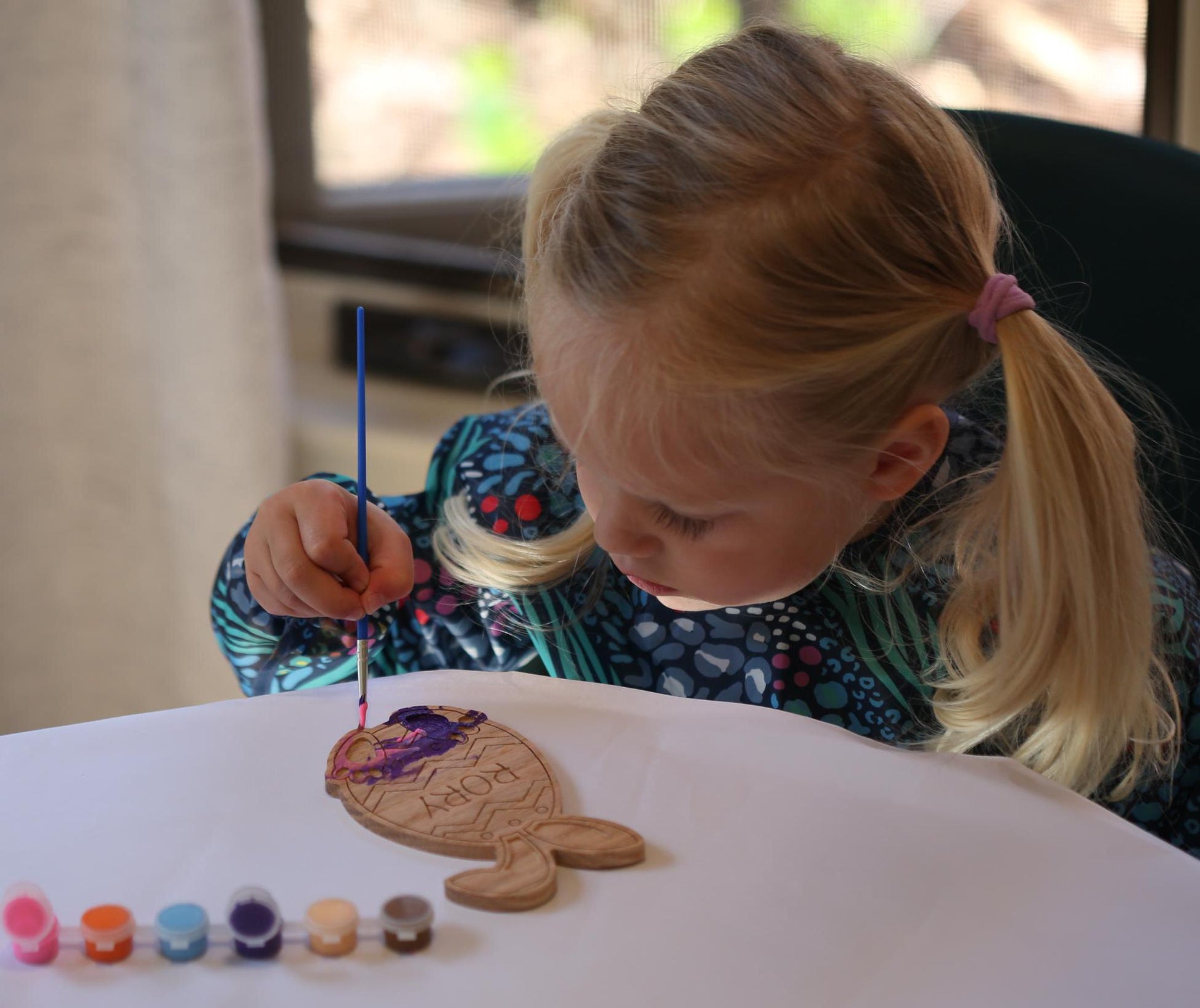 Child painting using Easter egg paint kit.